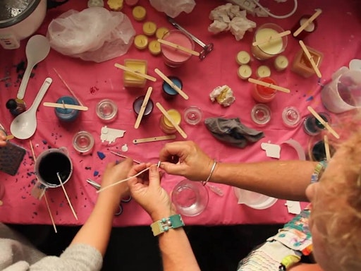 Busy hands at a candle making workshop